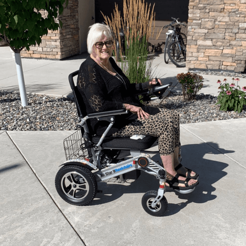 Senior woman sitting comfortably and confidently in an All Star power wheelchair outside her home