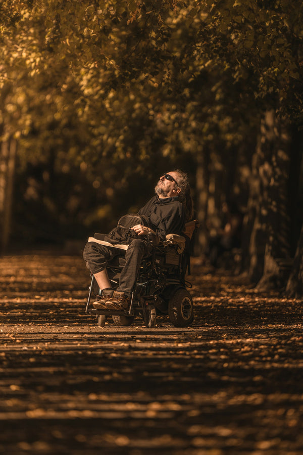 Man out in the park in his electric wheelchair — regular maintenance keeps your chair ready for every outing